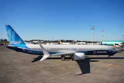 Boeing 737 commercial aircraft parked at airport with blue and white livery