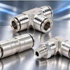 Stainless steel pneumatic push-to-connect fittings and tube connectors with brass accents on reflective surface