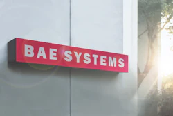 BAE Systems red and white exterior building sign mounted on modern facade with natural sunlight