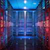 Modern data center server room with red cabinets, neon signage, and blue ambient lighting