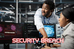 Two cybersecurity professionals monitoring computer screens displaying system hacked alerts and code in a data center environment