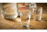 ManufacturingNow logo with glasses of water on wooden surface