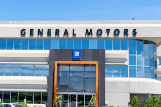 General Motors corporate headquarters building with blue glass windows and GM logo signage