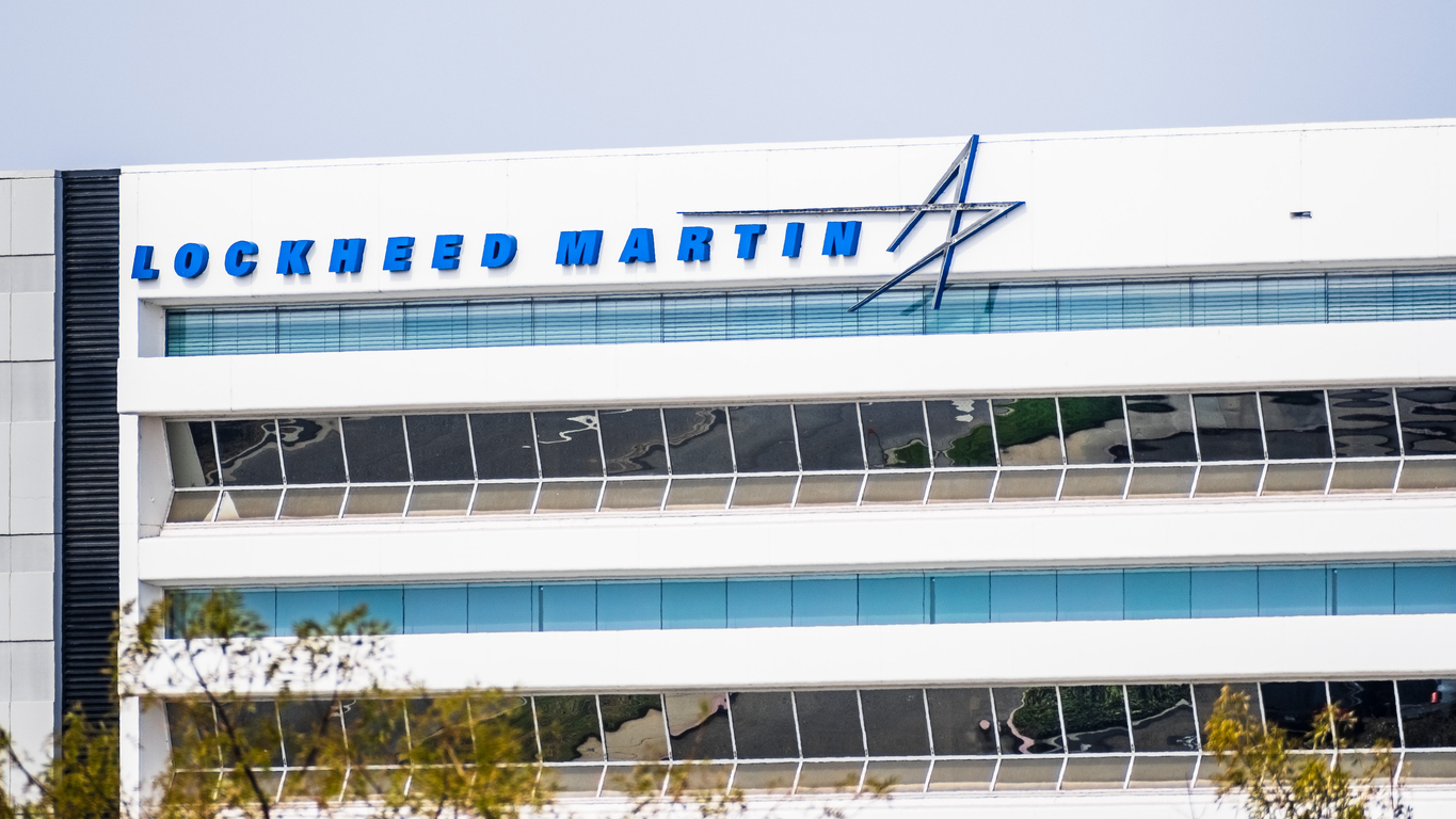 Lockheed Martin logo and text on modern white office building facade with blue glass windows