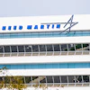 Lockheed Martin logo and text on modern white office building facade with blue glass windows