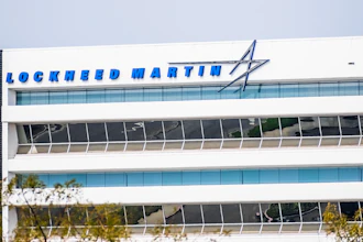 Lockheed Martin logo and text on modern white office building facade with blue glass windows