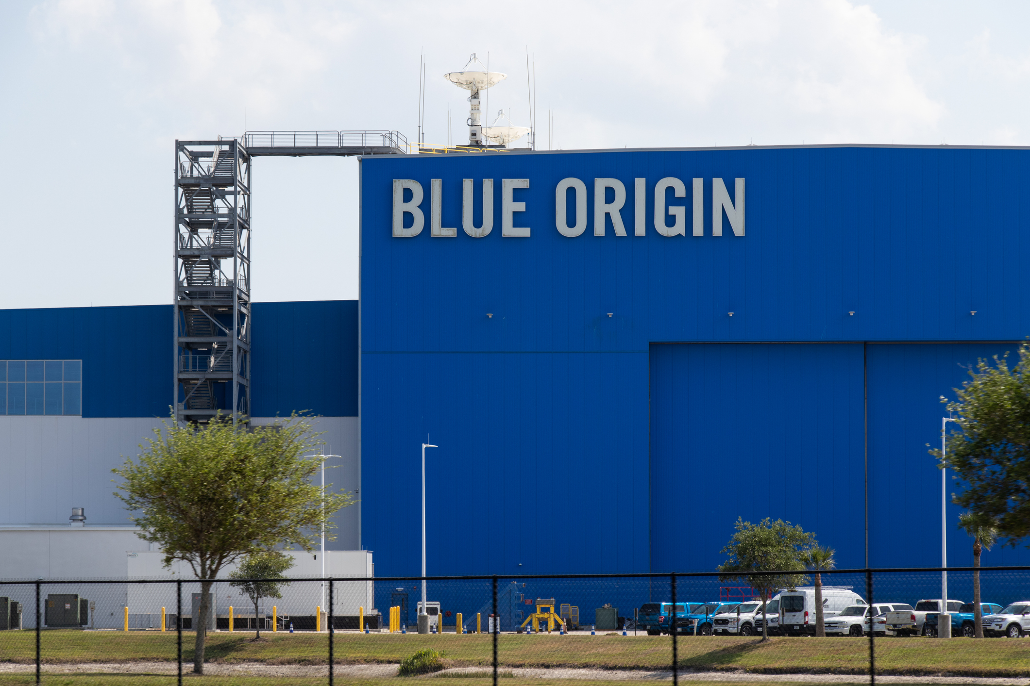 Blue Origin aerospace facility with large blue building facade displaying company name and launch tower