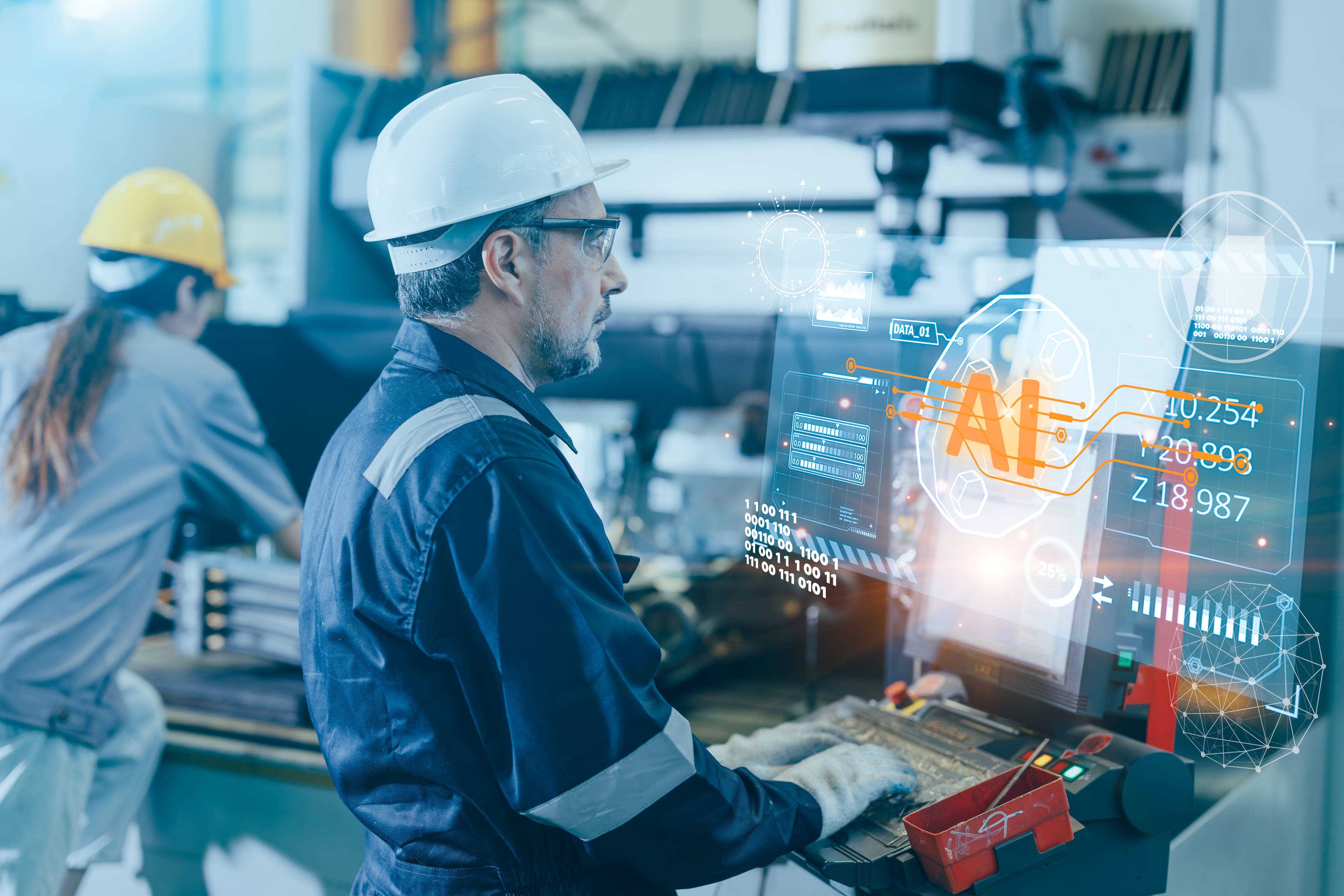 Industrial worker in hard hat using AR technology displaying AI analytics and data metrics on holographic display in manufacturing facility