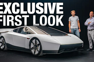 Exclusive first look at futuristic white concept car with two men standing beside it against dark background