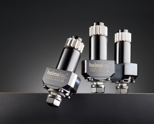 Three metallic Helmolux industrial pressure cartridge vessels with silver and black finishes displayed against dark background