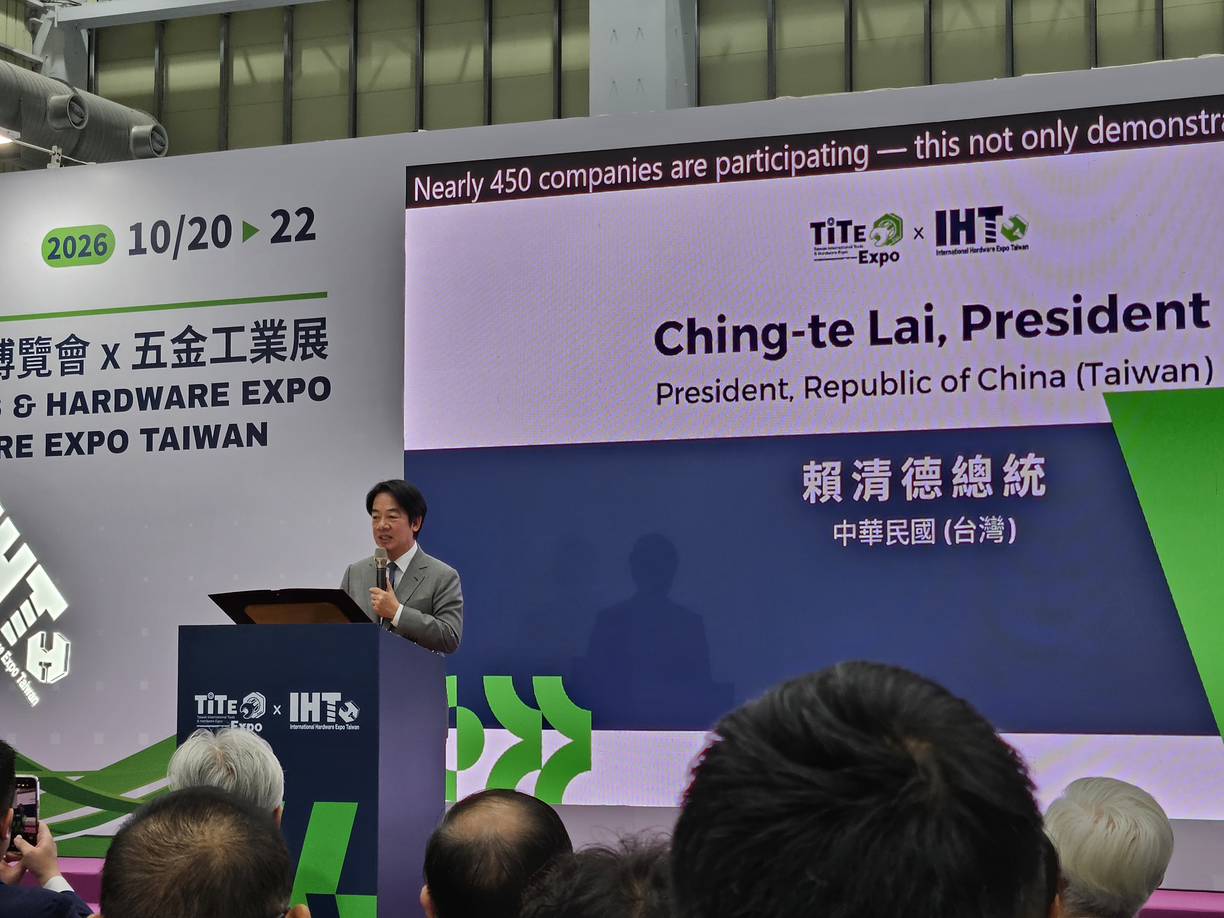 Speaker presenting at TITE and IHE Expo 2026 conference podium with event signage displaying Taiwan president information