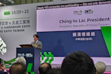 Speaker presenting at TITE and IHE Expo 2026 conference podium with event signage displaying Taiwan president information