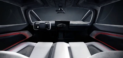 Modern car interior with steering wheel, digital dashboard display, and white seats with red trim accents