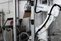 ASKAWA industrial robotic arm with tool changer mounted in manufacturing enclosure