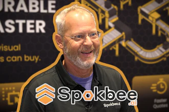 Man speaking at Spokbee corporate event with branded backdrop and logo watermark