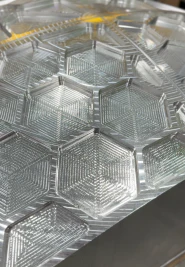 Stack of clear hexagonal plastic food containers with hinged lids