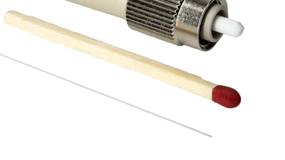 Fiber optic connector with green cable, metallic coupling nut, and ceramic ferrule tip displayed with applicator tools