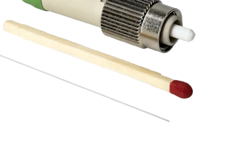 Fiber optic connector with green cable, metallic coupling nut, and ceramic ferrule tip displayed with applicator tools