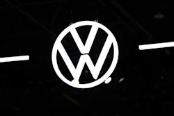 Volkswagen logo emblem illuminated against dark background