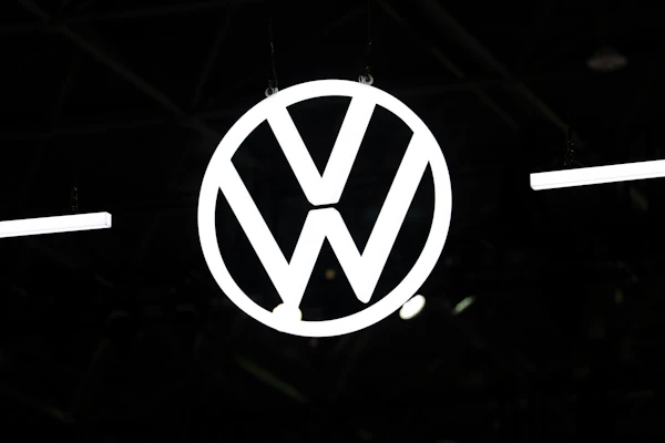 Volkswagen logo emblem illuminated against dark background