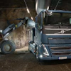 Volvo truck and wheel loader operating in an underground tunnel construction site with bright LED lighting