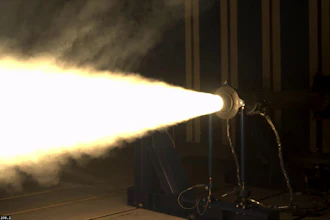 Theatrical spotlight projecting bright beam of light in dark stage environment